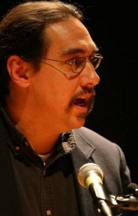 Image of the Director, Doctor Paul Ortiz in front of a mic