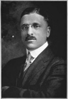 Photo of M. Vartan Malcom, stern looking man in suit and pince-nez