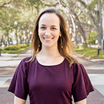 Anna Hamilton posed in front of a tree -lined street